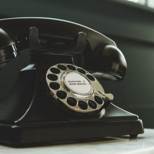 black-rotary-telephone-on-white-surface-1416530